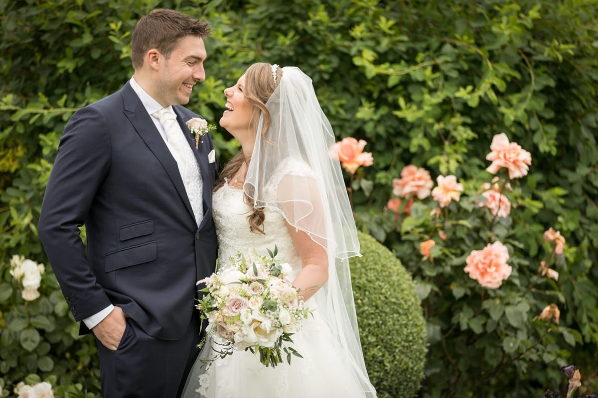 Bride and Groom in the Gaynes Park pergola with fairy lights Gaynes Park Wedding Photography