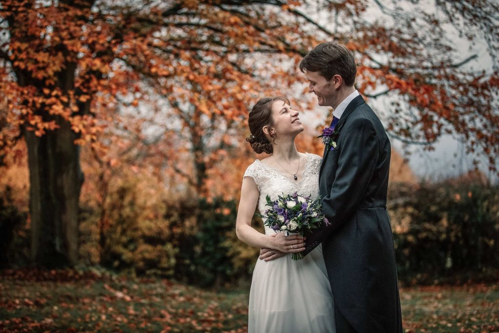Bride and groom with autumn leaves at Alswick Barn wedding in Buntingford, taken by Becky Harley Photography